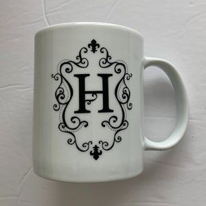 10 OZ COFFEE MUG MONOGRAM LETTER WHITE WITH BLACK LETTER 'H' ON SIDE.